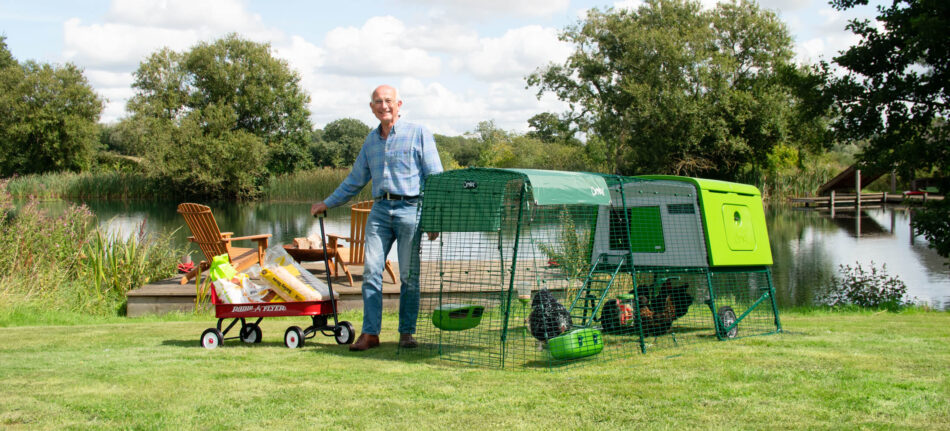 Man standing in front of Omlet Eglu Cube Chicken Coop with Run