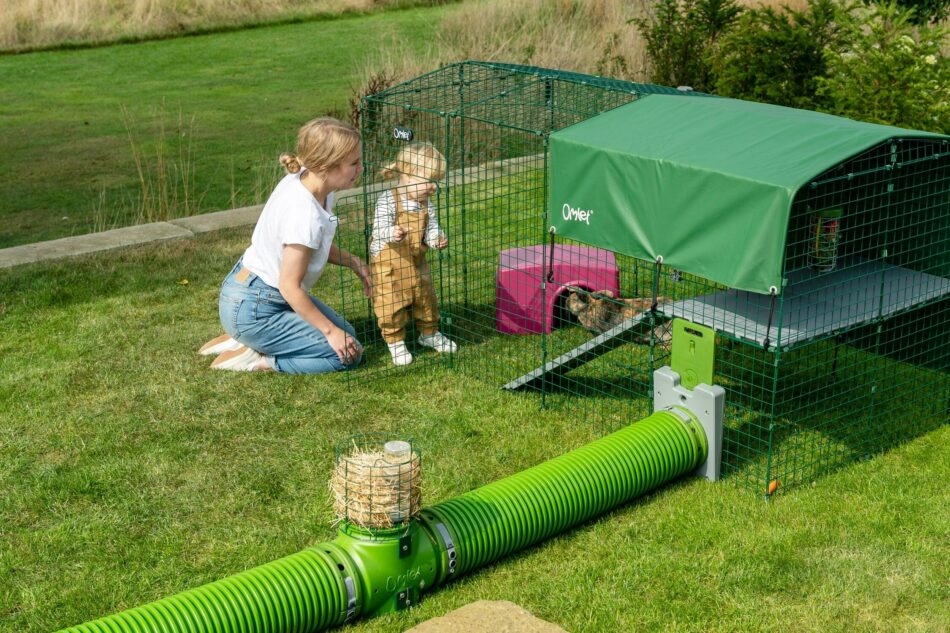 Mother and child with pet rabbits using Omlet's Zippi Tunnel System with Omlet rabbit Platforms