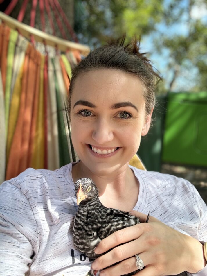 Alyssa Holland - raising chicks in fall - sat down holding a chick