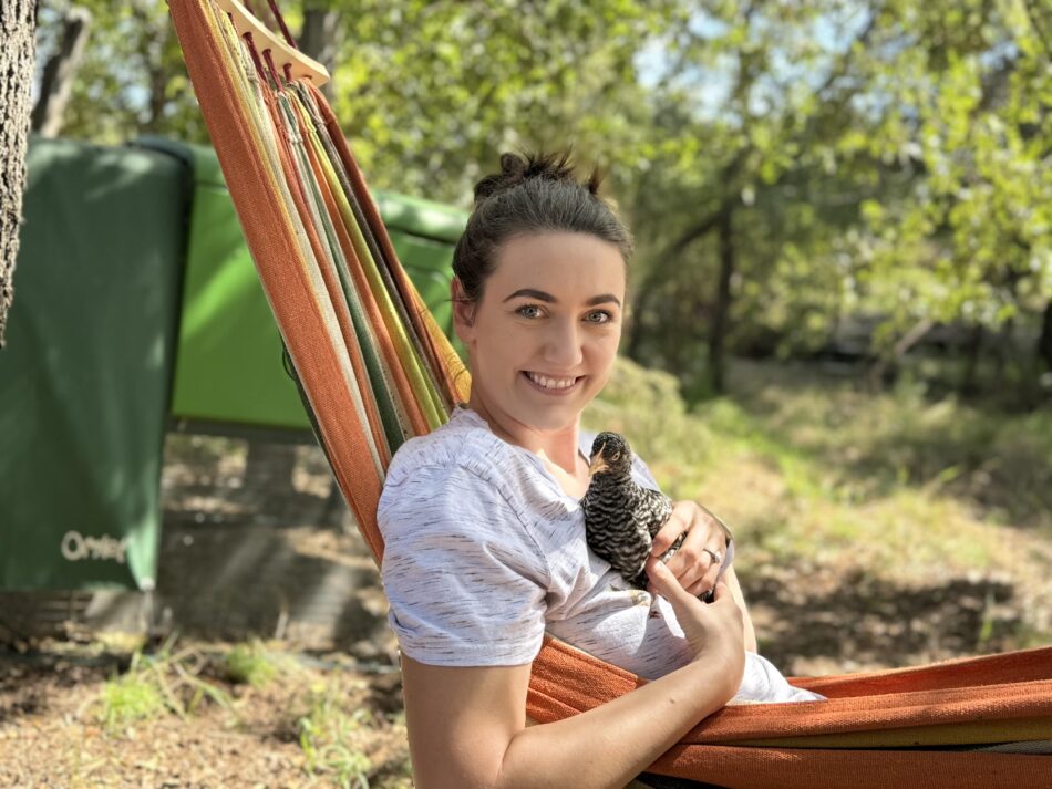 Alyssa Holland - raising chicks in fall - sat down holding a chick