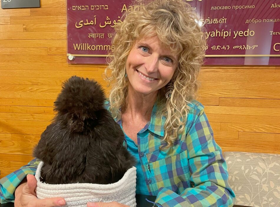 Tanya holding a chicken in a basket