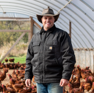 Daniel Salatin with a big group of chickens