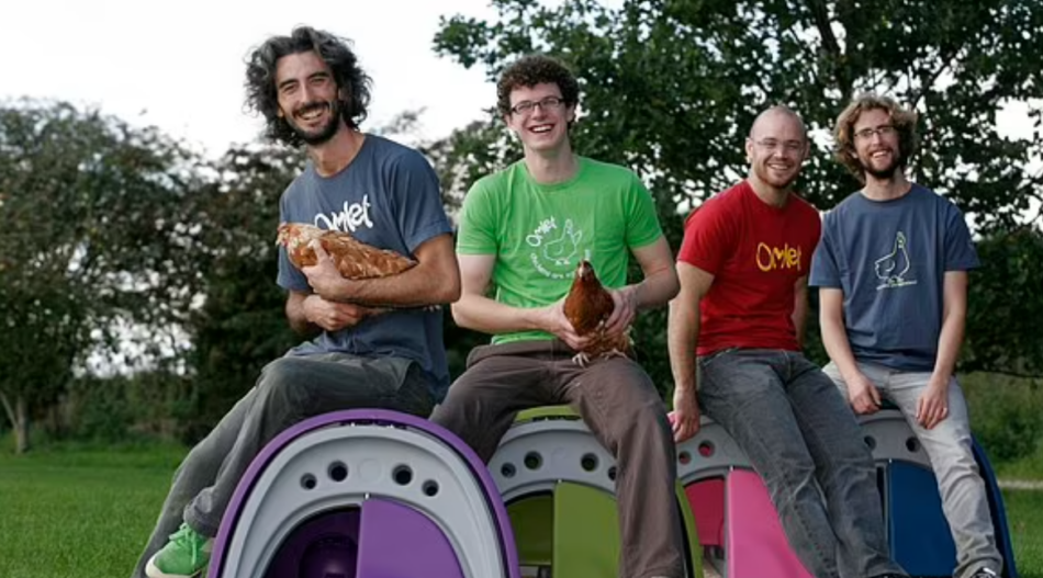 Omlet founders, Hanns, James, Simon and Will in the early days of Omlet. sitting on coops with chickens on their laps.